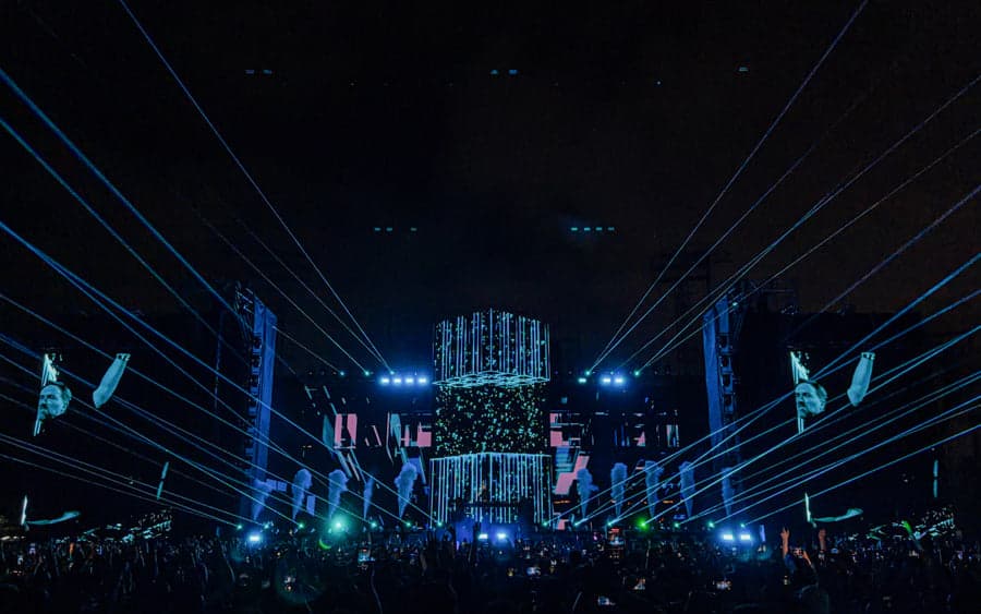 Blue laser lines extend across David Guetta’s Monolith stadium show