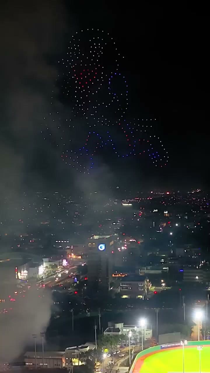 A drone formation depicts an athlete above the city